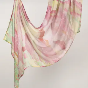 Detail view of lightweight watercolor print women long scarf pastel floral abstract shawl drape.