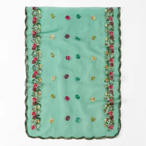 Green sheer scarf detail, delicate floral embroidery borders, lightweight breathable fabric close up.
