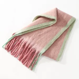 Detail shot of the pink color-blocked winter warm fringe scarf showing textured fabric.