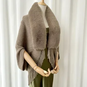 Knitted fringe shawl cape with fluffy plush fur collar for women, elegant warm winter outerwear.
