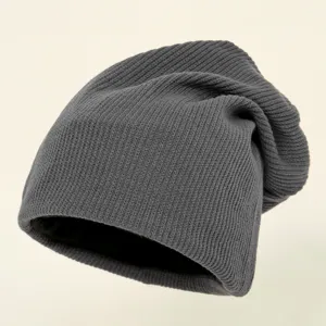 Dark gray knit beanie hat detail view, soft cozy winter warm slouchy cap for women styling.