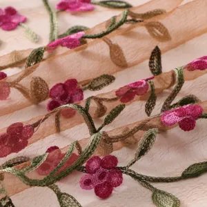 Detailed view of the sheer embroidered scarf, showcasing delicate floral patterns and texture.