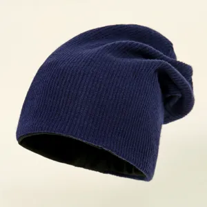 Deep blue knit slouchy beanie hat with warm black lining, soft ribbed texture for winter wear.