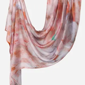 Close-up detail of women's digital printed cotton linen long scarf shawl, soft texture.