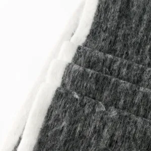 Detail shot of winter thickened warm color-blocking scarf, soft grey and white fabric texture.