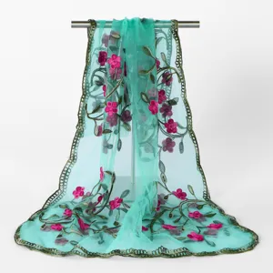 Detailed view of sheer mesh embroidered scarf with pink floral patterns and elegant drape.