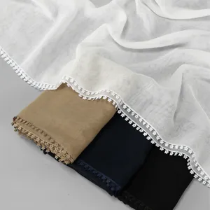 Elegant solid color women's gauze long scarf with delicate lace trim, soft shawl texture.