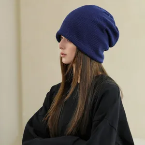 Side detail view of a soft knit slouchy beanie hat in deep blue, perfect for autumn winter cold.