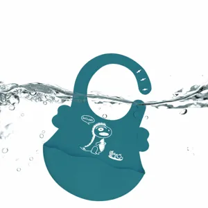 Waterproof silicone baby bib featuring cute dinosaur pattern, soft, and easy to clean.