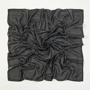 Detailed shot of black paisley pattern thin polyester square headscarf, elegant retro design.