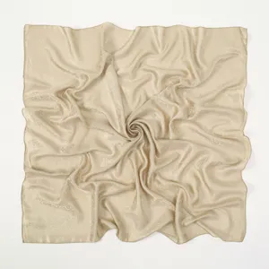 Detail view of the elegant vintage paisley square scarf, soft fabric texture and fine jacquard.