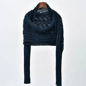Detailed view of the dark blue hollow-knit shawl with long sleeves, cozy winter apparel.