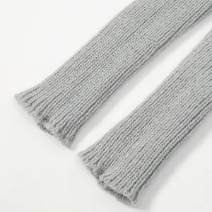 Close-up detail of grey ribbed knitted sleeves showing fine texture and soft winter material.