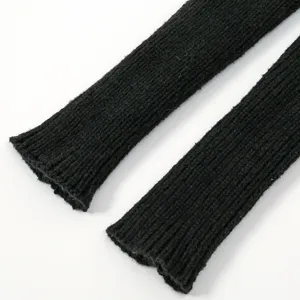 Detailed close-up of black ribbed knit arm warmers, showing fine texture and elasticity.