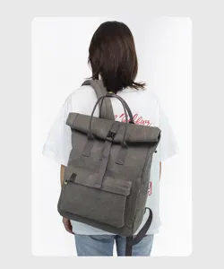 Grey canvas roll-top backpack for school, travel, and outdoor daily use with large capacity.