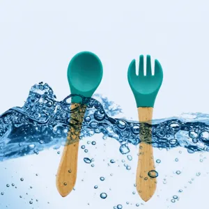 Wooden handle silicone baby spoon and fork set for infant feeding and baby training.