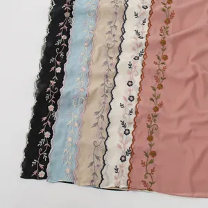 Detailed view showing exquisite floral embroidery lace edges and soft fabric texture of scarf.