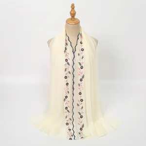 Detailed view of women's beige embroidered floral lace long scarf elegant summer shawl wrap.