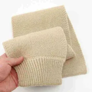 Beige knitted neck warmer detail view, soft winter scarf texture showcasing fine wool fabric.