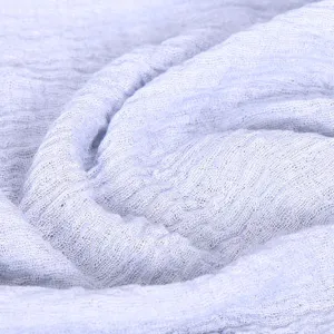 Light blue crinkled cotton linen scarf texture detail shot soft breathable versatile shawl.