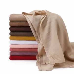 Detailed view of stacked multi-color modal scarves showcasing soft and breathable fabric quality.
