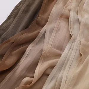 Close-up detail shot of lightweight breathable modal hijab scarf fabric texture in earth tones.