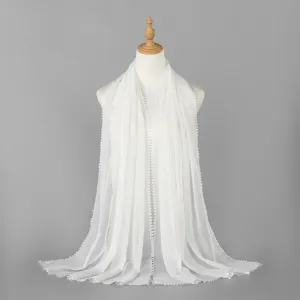 Detailed view of white women's long scarf featuring delicate lace trim and sheer fabric.