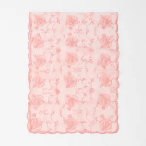 Detailed view of pink sheer mesh scarf featuring delicate rose embroidery and lace trim.
