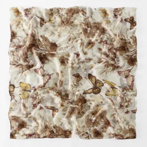 Detailed close-up of a vintage brown floral and butterfly printed lightweight fashion scarf.
