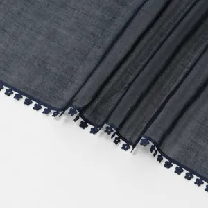 Close-up detail of dark blue gauze scarf with delicate flower lace trim edge soft texture