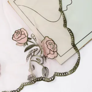 Exquisite pink rose floral embroidered mesh scarf detail, elegant sheer fabric accessory.