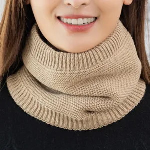 Close-up detail of knitted winter neck warmer snood, soft textured thermal scarf for cold days