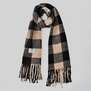 Cozy winter plaid scarf featuring soft textured fabric, elegant fringe and stylish block pattern.