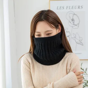 Black knitted neck warmer scarf detail showing cozy ribbed winter thermal winter gear.