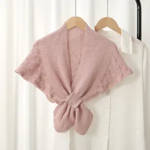 Pink knitted small shawl cape detail view, elegant women's outerwear shoulder wrap for wear.