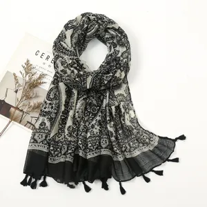 Black and white paisley pattern cotton linen feel long scarf with decorative tassels.