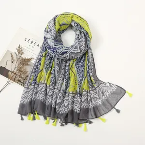 Detailed view of the women's ethnic geometric print scarf with tassels, soft linen-feel fabric.