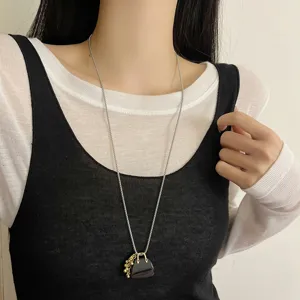 Long sweater chain necklace featuring a cute mini handbag pendant with delicate grape charms.