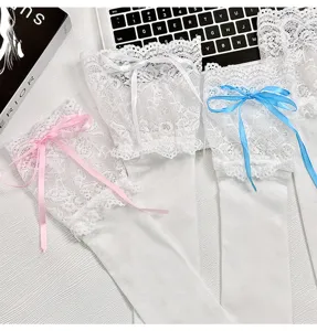 Detailed view of white lace over-the-knee socks with colorful ribbon bows, perfect Lolita style.