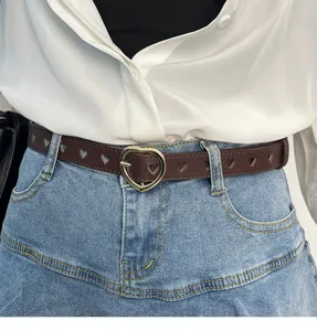 Women's brown leather belt with cute heart-shaped buckle and hollow cutouts for jeans.