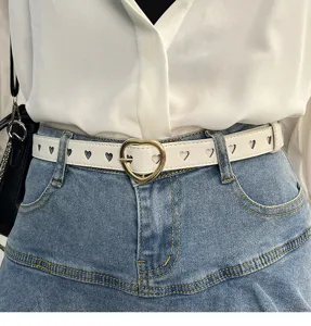 Heart buckle white belt detail view, featuring cutout heart design and gold-tone hardware.