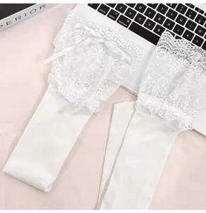 White Lolita lace over-the-knee socks detail view, featuring delicate bows and cute ruffles.