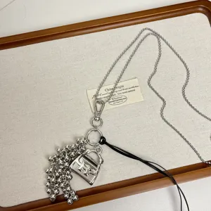 Metal bag pendant grape cluster long sweater chain necklace, niche design fashion jewelry.