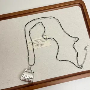 Stylish metal handbag pendant layered necklace with black cord and silver chain for women.
