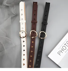 Heart cutout slim women belt detail view, minimalist pin buckle faux leather casual pants accessory.