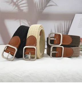 Close-up detail of casual woven elastic belt with stylish metal square buckle and leather ends.