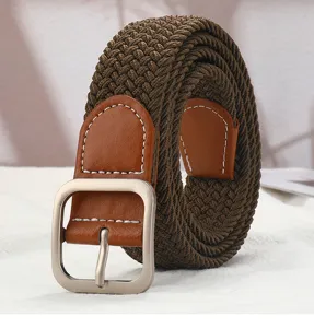 Close-up view of brown woven belt with leather trim and silver square buckle detail.