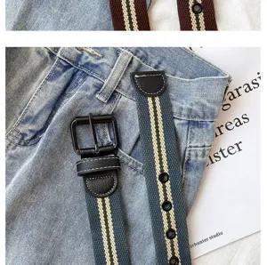 Close-up detail of stylish canvas belt with metal buckle and striped design for casual wear.