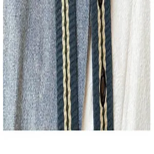 Canvas belt detail close-up showing woven striped texture and hole design for casual men women