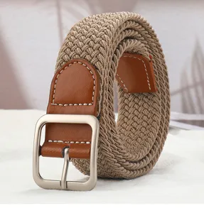 Close-up of a braided elastic belt with brown leather trim and a sleek silver metal pin buckle.